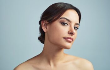 Woman, portrait or beauty in studio for skincare, makeup or confidence with cosmetics. Dermatology, girl or collagen treatment on gray background space with satisfaction, aesthetic or retinol results